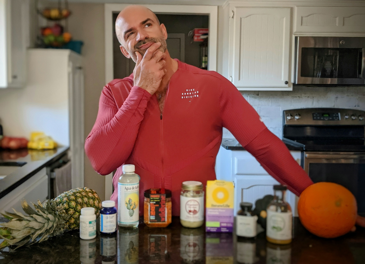 Ryan thinking about choosing best probiotics, in kitchen